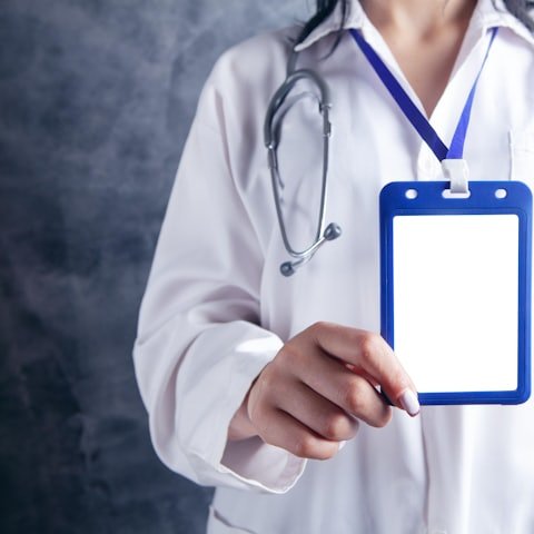 Clinician holding a provider credentialing badge